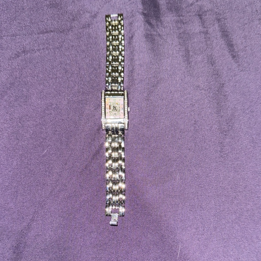 Stainless Steel Watch with mother of pearl designed dial/rhinestone accents.
